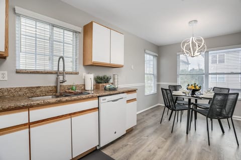 Discover the perfect blend of style and function in this inviting kitchen, featuring elegant granite countertops and a cozy table for four to enjoy delightful meals together.