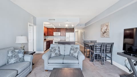 Open-concept living and dining area with modern kitchen and comfortable seating.