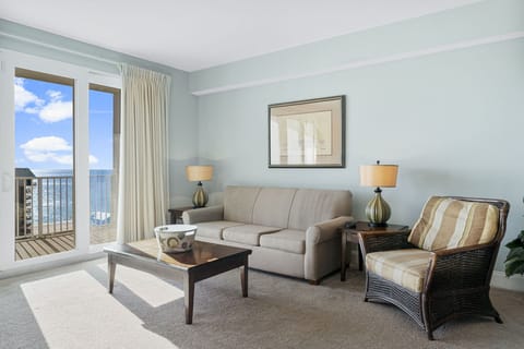 Relax in this bright living room with ocean views and comfortable seating.