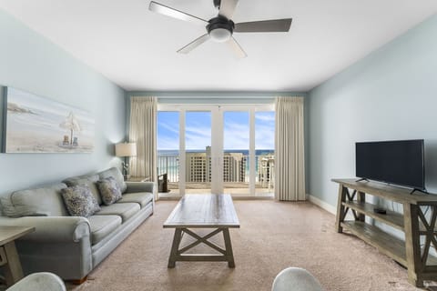 Relax in this coastal living room with ocean views through large glass doors.