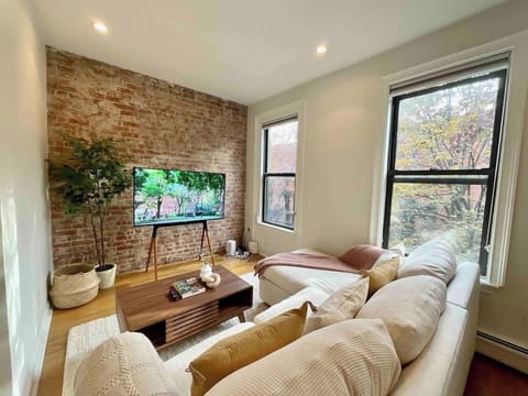 Historic home, brick wall, Roku TVs, L-Shape Couch, Coffee Table, Large Windows