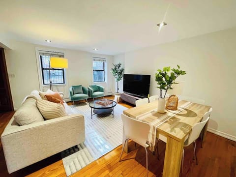 Historic home with exposed brick wall, couch, dining room with chairs, Roku TV.