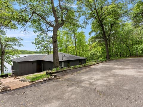 Lakefront retreat nestled among mature trees with convenient parking and peaceful natural surroundings just steps from the water's edge.