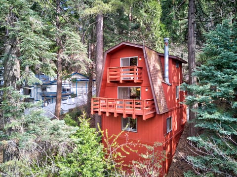 Rear of cabin with double deck balconies extending out to mountain views