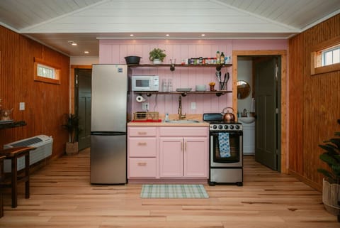 Whip up breakfast in a kitchen as cute as your weekend getaway- yes, the cabinets are pink!