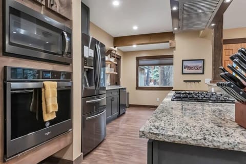 The kitchen boasts ample counter space, beautiful cabinets and woodwork, stainless steel appliances, and all the basic cookware to easily whip up some delicious meals at home.