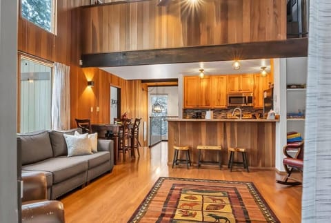 The view from the living room towards the kitchen. The main living space offers plenty of natural light and an abundance of seating, the perfect area for gathering!