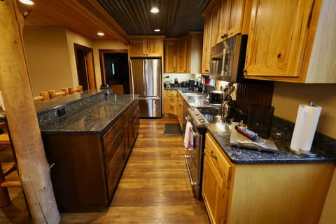 Full kitchen with stainless steel appliances. 