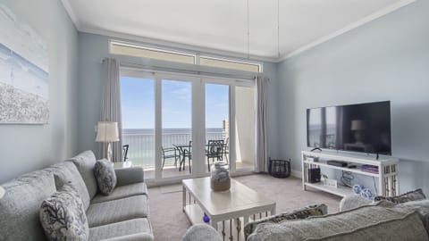 Relax in this modern living room with ocean views and balcony access.