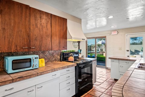 Kitchen stove with range hood and cupboards