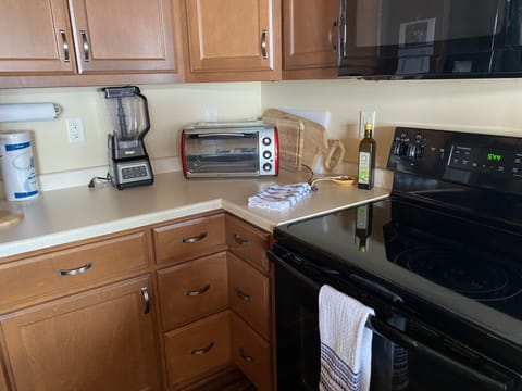 The kitchen has a Ninja food processor, toaster oven and coffee maker