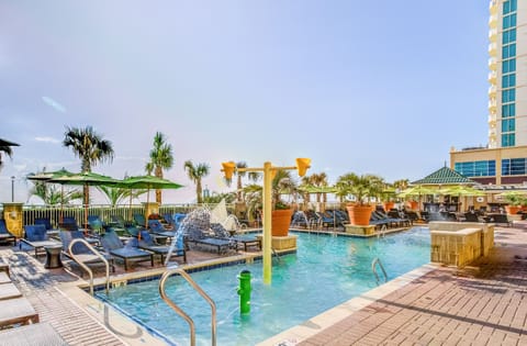 Splash and unwind in the sparkling pool with palm views.