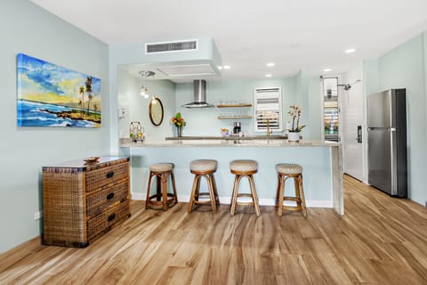 Open Kitchen with Island Seating - Bright, remodeled kitchen featuring a spacious island with bar seating, modern finishes, and an open layout ideal for gathering.