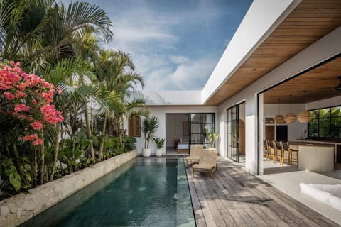 Outdoor area with daybeds next to the pool.