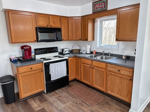 Kitchen with Keurig, basic cooking & cleaning essentials.