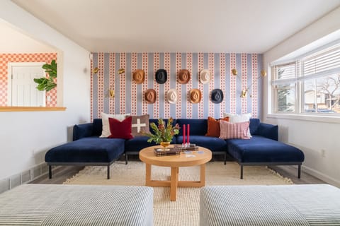 Living room with large plush couch and cowboy hat display