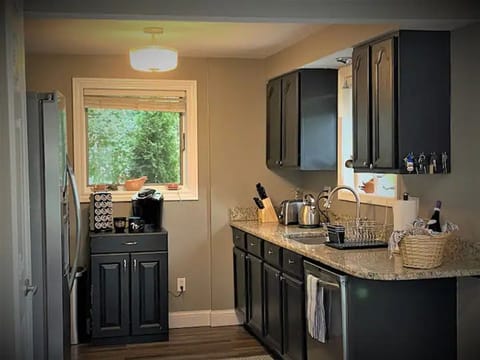 Full kitchen with stainless appliances and dishwasher.
