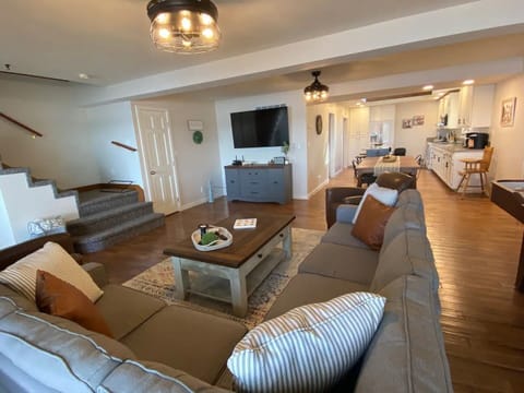 Massive living room that includes a large, flat screen smart TV.