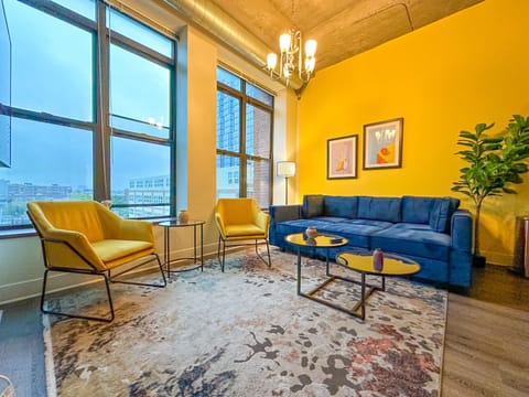 Spacious living room with a lot of natural light and large windows.