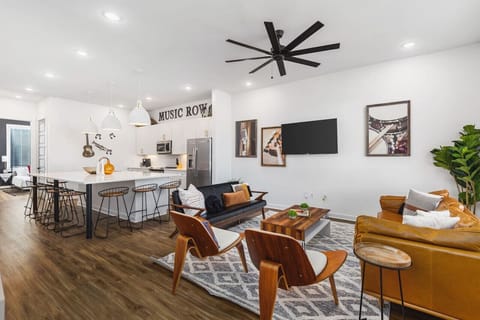 Spacious kitchen & living areas with a Smart TV,  comfortable furnishings, and plenty of seating for your group to kick back after exploring the city.