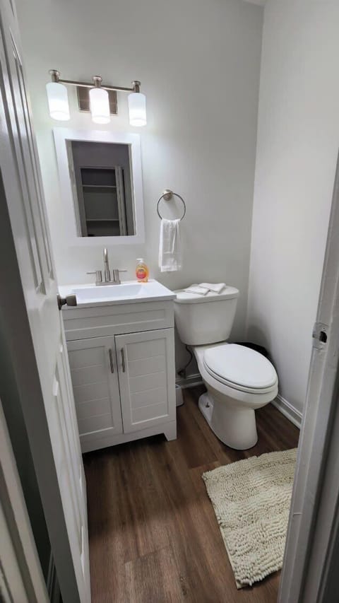 Half Bathroom: Freshen up in our sleek, modern bathroom, stocked with toiletries and a spacious vanity for your convenience.