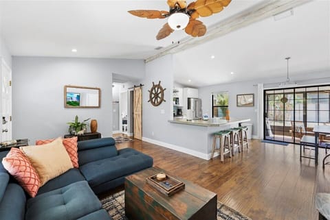 Open living space with kitchen island, seating, and easy indoor-outdoor flow.
