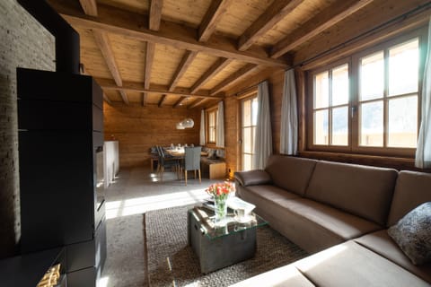 Bright living room with timber ceiling and cosy sofa area