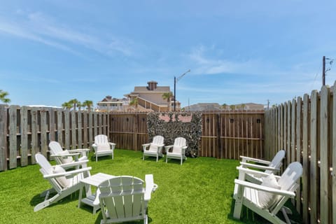 Gather with family and friends in this inviting outdoor space, featuring comfortable seating and a private fenced yard perfect for enjoying the fresh coastal air.
