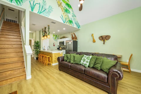 Unwind in your stylish safari-themed living space with plush leather sofa, full kitchen, and whimsical jungle touches throughout.