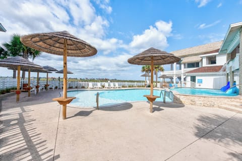 Dive into your private oasis with tropical thatched umbrellas providing perfect poolside shade while you soak up the Florida sunshine.