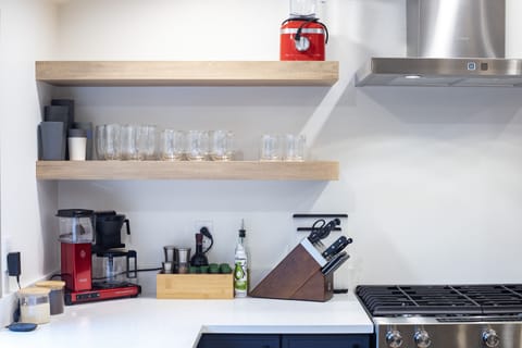 Fully stocked kitchen includes spices, cooking oils, Zwilling knives and glasses