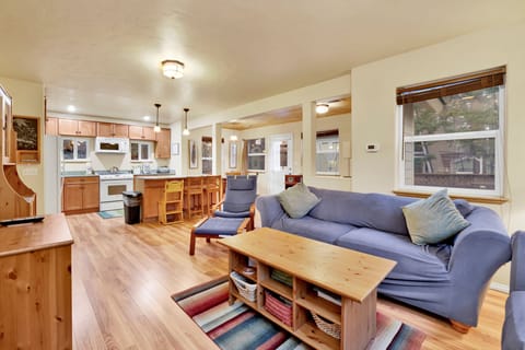 Cozy mountain living room with a fireplace, comfy seating, and smart TV—perfect for relaxing evenings, movie nights, and warm cabin vibes after outdoor adventures.