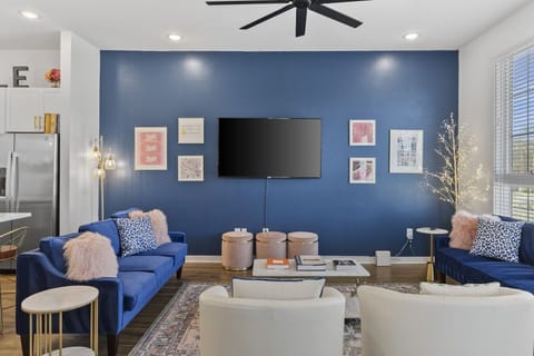 Living room with two comfy couches, a ceiling fan, and a Smart TV with all the streaming apps. Plenty of seating here & in the kitchen for your family to unwind.
