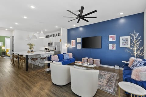 Living room with two comfy couches, a ceiling fan, and a Smart TV with all the streaming apps. Plenty of seating here & in the kitchen for your family to unwind.