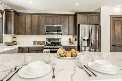 The generous kitchen peninsula is made for casual moments—coffee in the morning, après snacks in the afternoon, and easy conversations that linger into the evening.