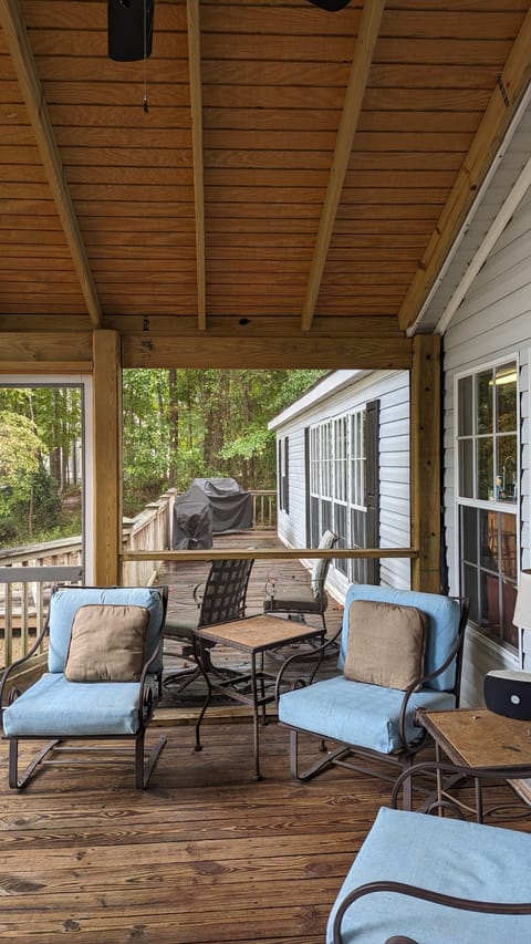 Back deck is length of home, grills on end near steps.
