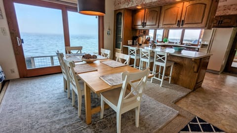 Dining area with sliding doors to the waterside patio