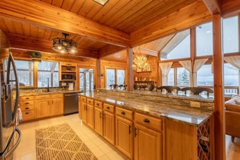 View of the kitchen/dining area and the floor to ceiling windows.