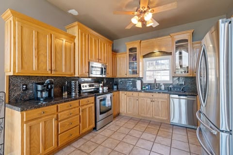 Fully stocked kitchen with plenty of light coming through the bay windows