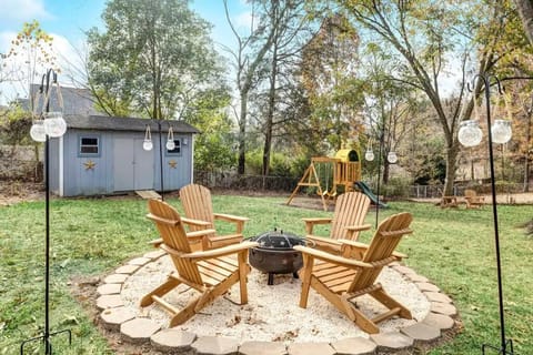 Large, gated backyard with firepit and play structure