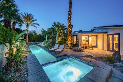 Private pool & spa retreat framed by palm trees and desert skies.