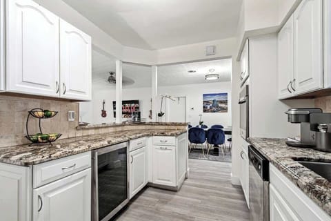 - Spacious kitchen with granite countertops and bright design  
- Open layout flows into dining area with modern seating  
- Fully equipped for group cooking and shared meals  