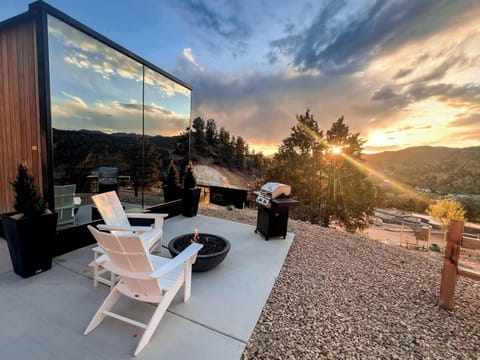 Mirror House exterior at sunset, designed to reflect the surrounding cliffs, trees, and Southern Utah sky.