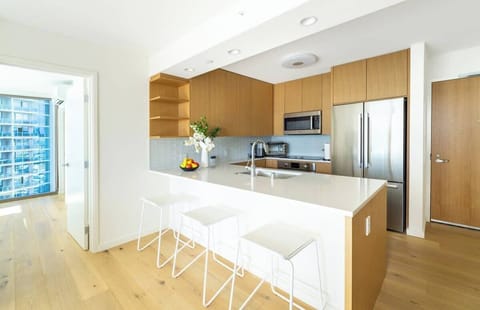 The special dining table and chairs give it a unique touch, making the space look cool. With its neat design and calm colors, this kitchen becomes a happy place to eat and make great memories.