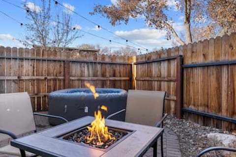 Soak in our roomy hot tub or warm up by the fire pit while enjoying some fresh air on our back patio!