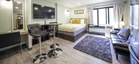 Queen size bed, futon couch, and storage in cubicles and drawers attached to bed. Portable AC.