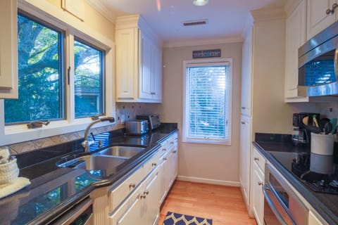 The kitchen features granite countertops and custom cabinetry.