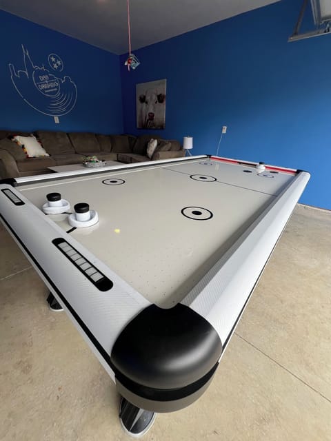 GAME ROOM - Our game room is perfect for some indoor fun, featuring an air hockey table, comfy seating, a large 40" TV, and vibrant decor. A great spot to relax and enjoy with friends or family!