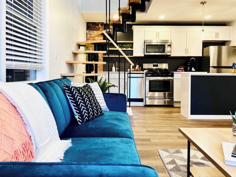 The blue velvet sleeper sofa is perfect for catching a movie on the smart tv or folding out for extra guests!