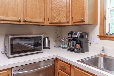 Kitchen essentials - Microwave, electric water boiler, dishwasher and Keirug coffee maker.